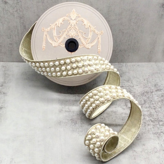 A metallic dupion pearls trim with a central disc, surrounded by a series of pearl-studded straps extending outward, against a grey background.