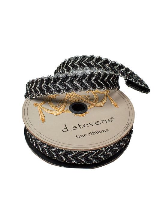 Spool of black and silver ribbon with 'd.stevens' label on a white background