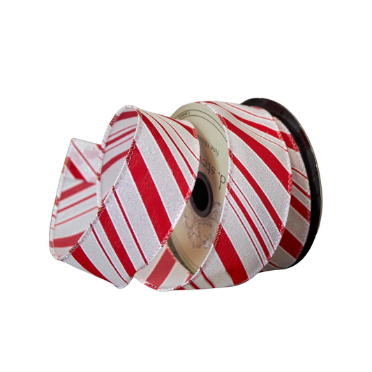 Spool of red and white striped ribbon on a white background
