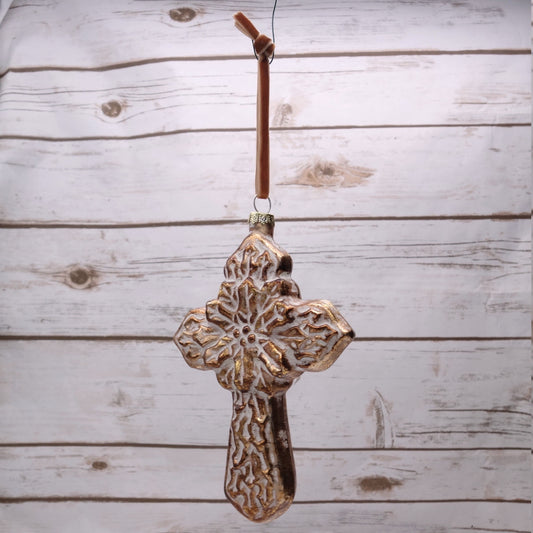 A 6-inch glass sculpted cross ornament hanging against a wooden backdrop.