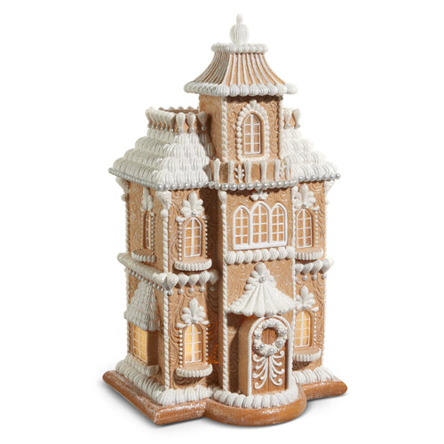 Resin gingerbread house with detailed icing on a white background