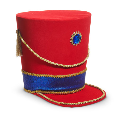 Red nutcracker hat with blue band and gold tassel on a white background