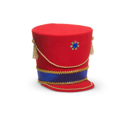 Red nutcracker hat with blue band and decorative elements on a white background
