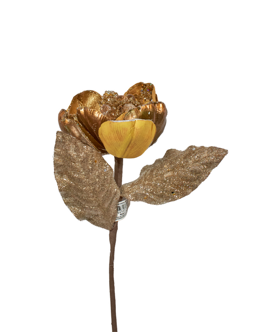 Gold-colored magnolia with glittery leaves on a white background