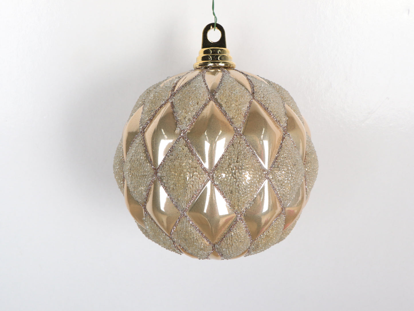 Decorative Christmas ball with diamond pattern on a white background