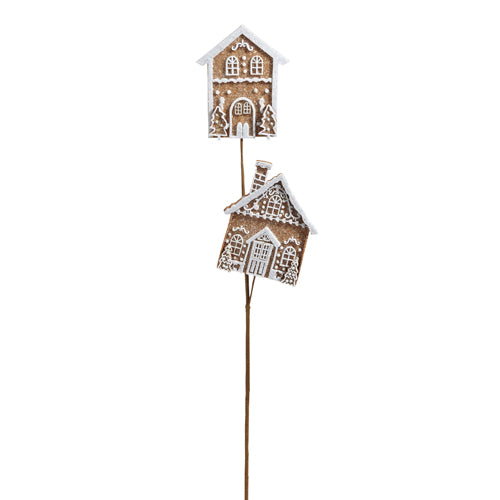 Decorative holiday spray stem with gingerbread house-shaped top on a white background