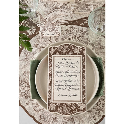 Decorative place setting with a menu card on a patterned tablecloth