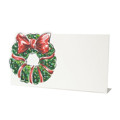 Card with a Christmas wreath design featuring red bows on a white background
