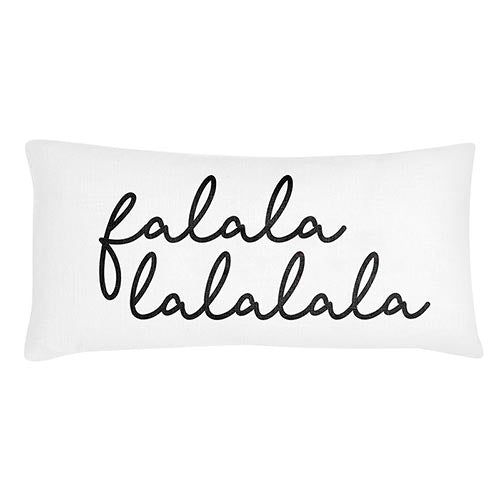 A white lumbar pillow with the text 'falalalalala' printed in a black, festive script.