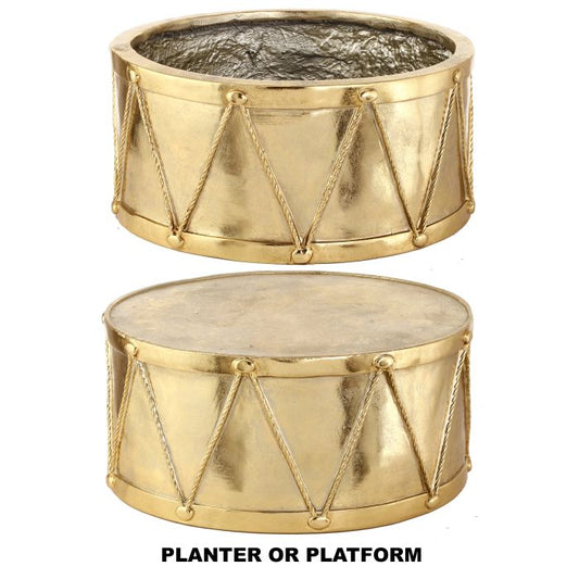 Two gold metal planters drums with decorative chains on a white background