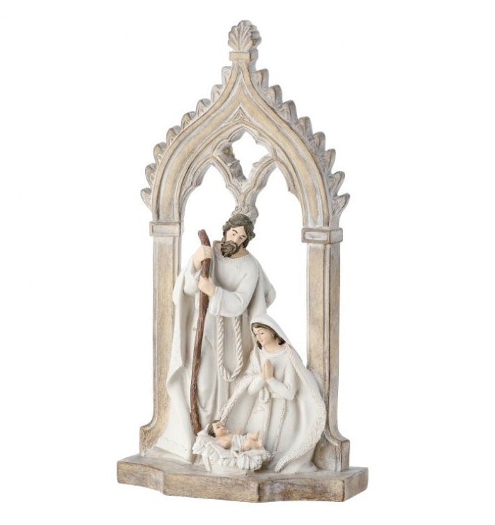 A resin figurine of the Holy Family, consisting of a man, a woman, and a child, set within an arched frame.