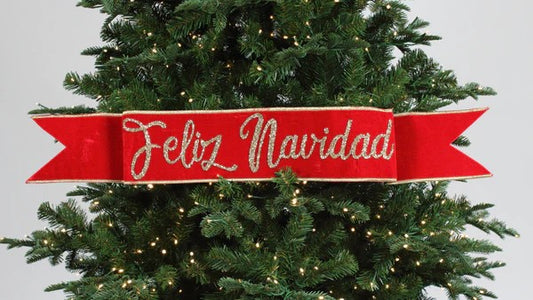 A red and green velvet banner with 'Feliz Navidad' text, designed for hanging on a Christmas tree or as holiday decor.