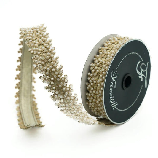 A spool of pearl vine ribbon with beads, used for crafting.