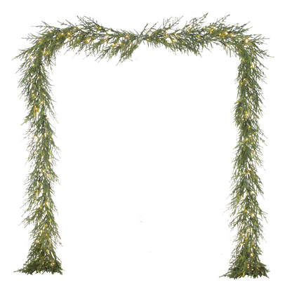Decorative green garland arch with lights on a white background