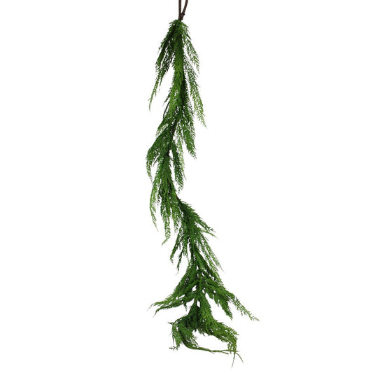 Artificial green vine hanging on a white background