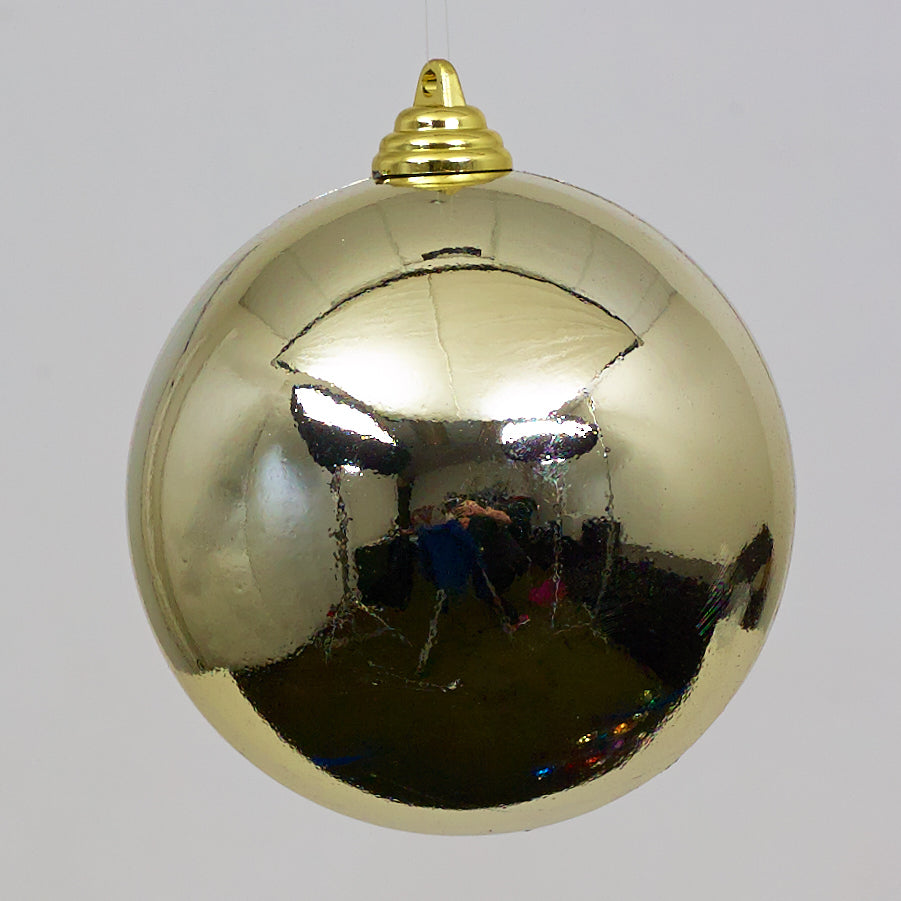 Gold Christmas ball ornament on a white background