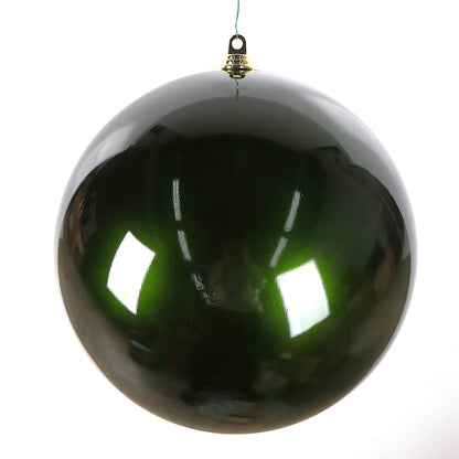 Shiny green Christmas ball ornament on a white background