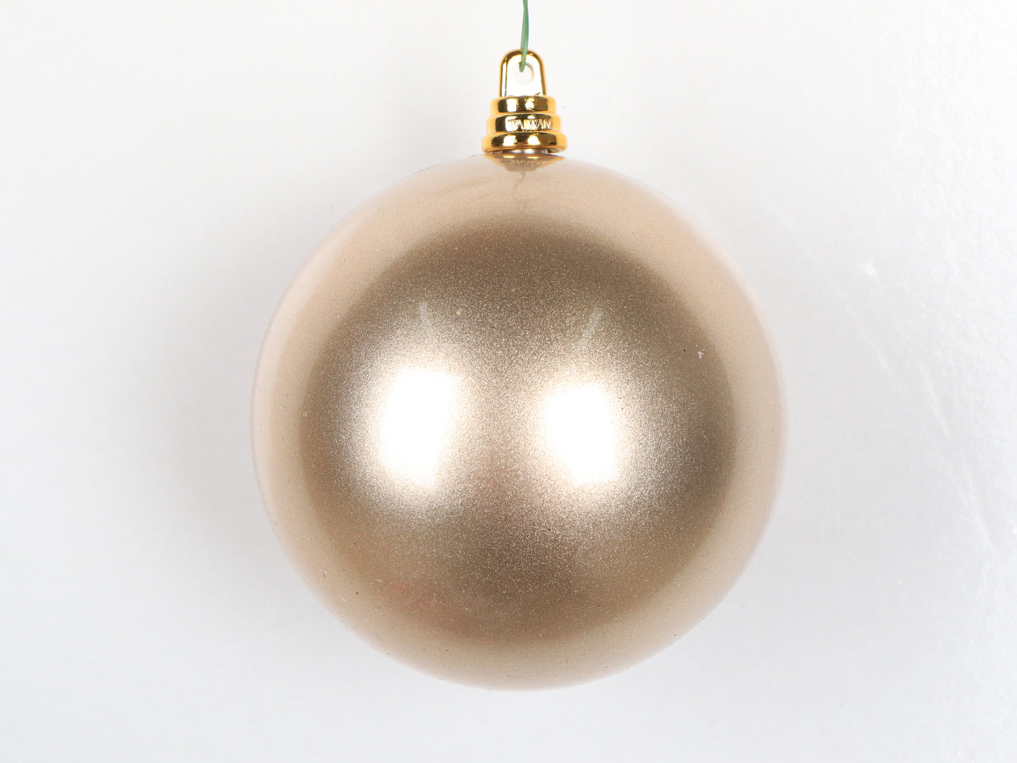 Champagne Christmas ornament on a white background
