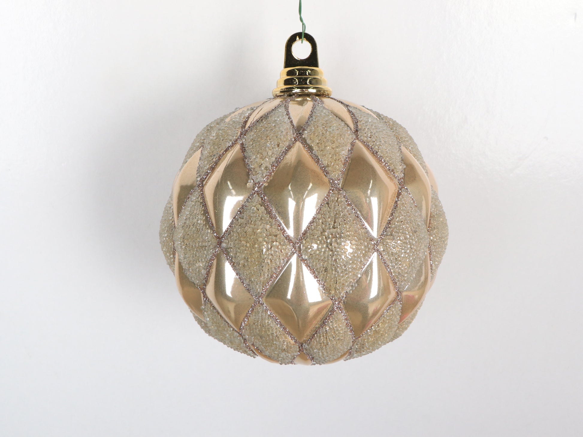 Decorative Christmas ball with diamond pattern on a white background