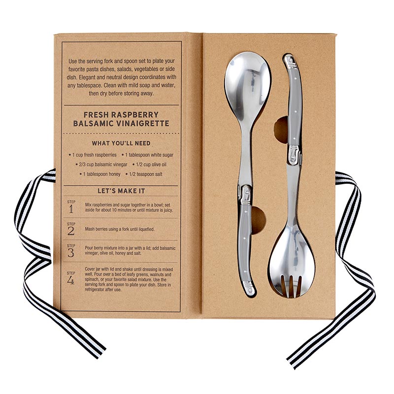 Spoon and fork set in a cardboard box with recipe card on a white background