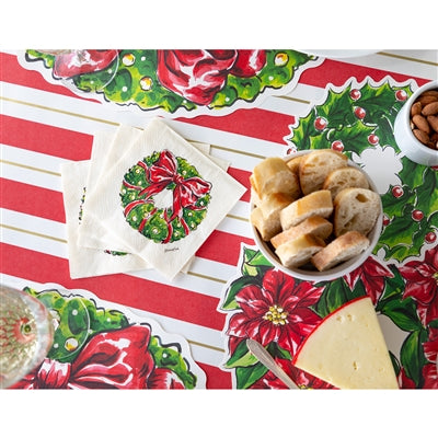 Holiday-themed tablecloth with festive designs and food items on a table.