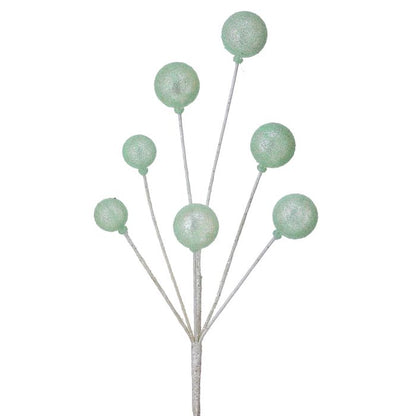 Decorative stem with green spherical beads on a white background