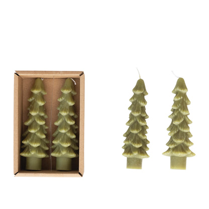 Two tree-shaped candles with one in a cardboard box on a white background