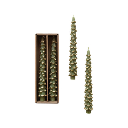 Set of green tree-shaped candles with a box on a white background