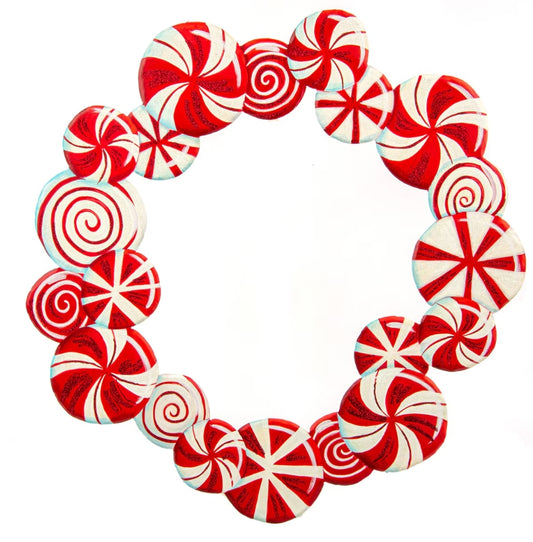 Red and white peppermint candy arranged in a circular wreath shape on a white background