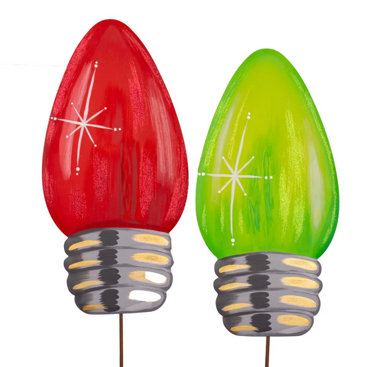Red and green Christmas light bulb-shaped stakes on a white background